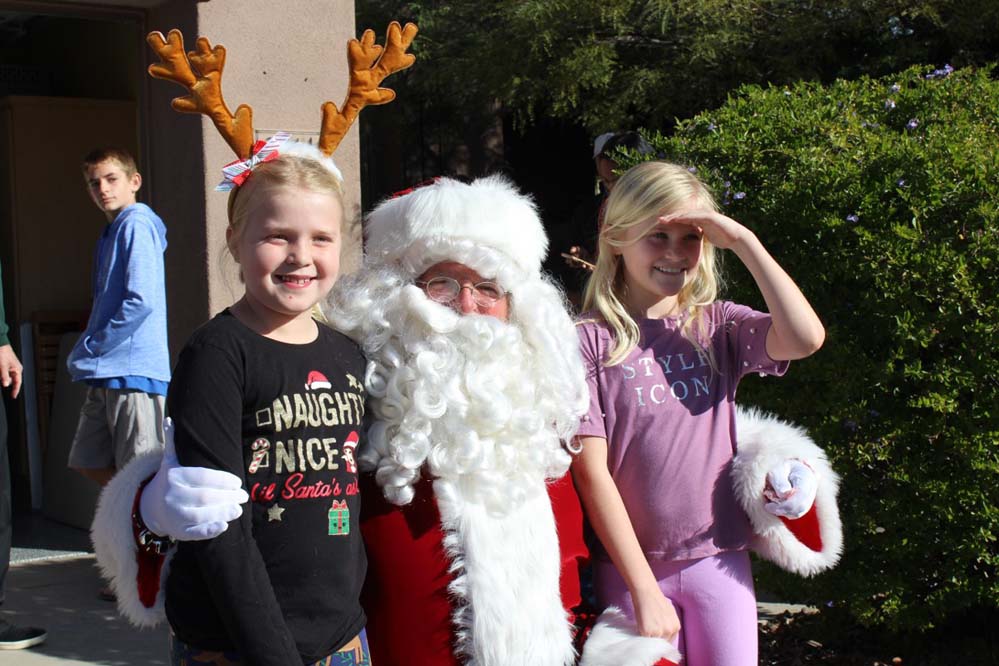 Two kids having a picture with Santa